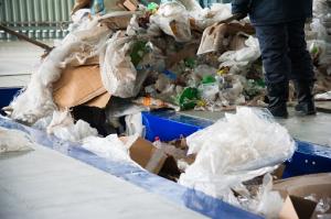 Cropped view of a waste collection crew efficiently gathering commercial plastic materials for recycling.