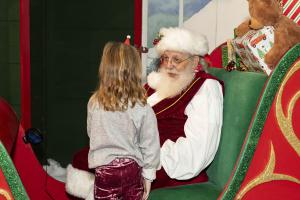 Santa visits with a child at the Southern Christmas Show