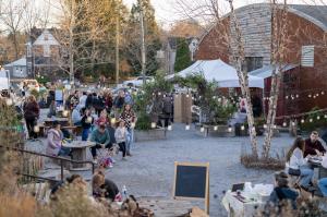 Families enjoying the festive atmosphere at The Holiday Village Market - open air shopping experienceosphere