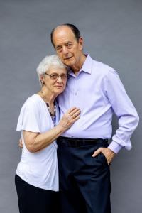 An older couple smiling at the camera.
