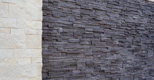 Close up of a completed Stone Panel+ wall section with light stone veneer on the left and dark stacked stone veneer on the right, demonstrating the system’s clean alignment and finished look.