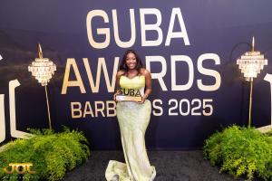 A 2025 GUBA Awards honoree Charlotte Magayicelebrates her achievement at the Miller Holding-sponsored gala held at Wyndham Grand Barbados, Sam Lord's Castle Resort, where excellence across business, entertainment, public service, and diaspora leadership was recognized.
