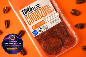 Texas Iberico® has been named the Winner in the Consumer Product category at the Greater Austin Business Awards, hosted by the Austin Chamber of Commerce Package of Texas Iberico Spicy Pecan Cold-Smoked Chorizo on an orange background with pecans and a Greater Austin Business Award Winner badge.