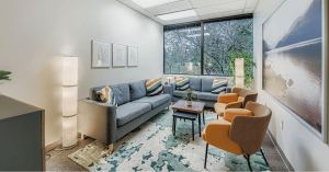 Comfortable counseling office at Eastside Counseling Center with sofas, warm lighting, and a peaceful environment used for grief therapy sessions.