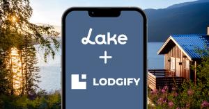 Lake.com and Lodgify partnership announcement, image of a lake house by the mountains.