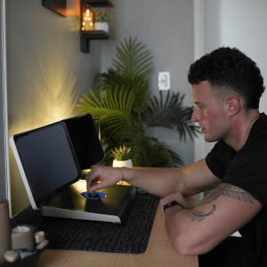 Man using Cognivue’s motorized dial for a simple cognitive health assessment in a modern, calming setting.