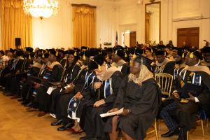 Graduates from the Class of 2025 gather during the commencement ceremony, representing diverse professional backgrounds and countries from around the world