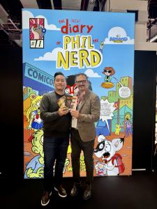 PLAYCURIO CEO Sangjun Lee (left) nd Almond Entertainment CEO Dario Gulli (right), posing in front of their joint booth at Frankfurt Book Fair