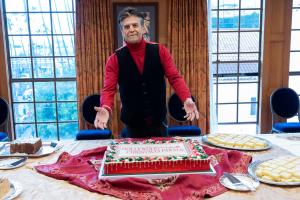 Actor and parade host, Eric Estrada, in the L. Ron Hubbard Theatre green room with a special cake made by Cake and Art.