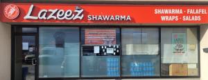 Streetfront view of Dixie & Aimco Lazeez Shawarma location with a bright red storefront sign, large front window.