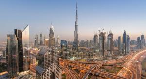 Panoramic view of the Dubai skyline at sunset featuring the Burj Khalifa (World's Tallest Building), and surrounding skyscrapers in Downtown Dubai.