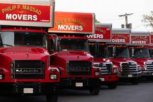 Philip P. Massad Movers Expands Boston Moving Services, Offering Premium Relocation Solutions Across Greater Boston Area 19 Row of red Philip P. Massad Movers Mack trucks lined up showing the company's professional moving fleet in Massachusetts