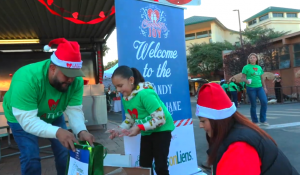 A family enjoying Candy Cane Lane at LATLC's Comfort & Joy,
