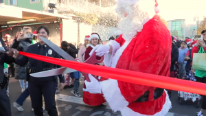 Santa Claus Cutting The Ribbon for LATLC's Comfort & Joy,