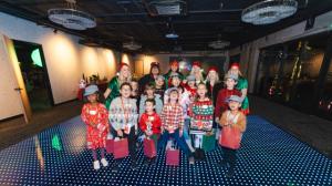 Smiling volunteers dressed in elf costumes