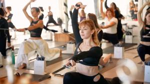 Woman practicing sword yoga at WeaponUps in-person event