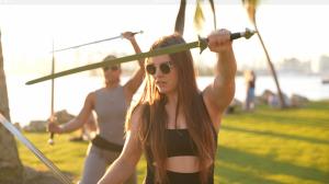 WeaponUp instructor practicing sword yoga on the beach