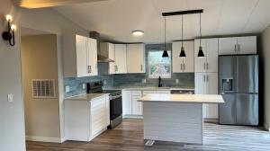 Contemporary kitchen displaying high-quality cabinetry, curated materials, professional lighting design, and premium appliances that combine form and function.