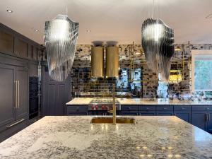 Luxury kitchen remodeling project showcasing optimized layout, expert cabinetry with storage solutions, comprehensive lighting design, and seamless integration of natural light.