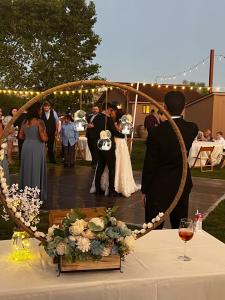 Outdoor wedding reception at Alcantara Vineyards featuring the couple’s first dance under string lights with guests gathered on the lawn.