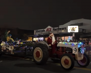 Russian River RailBikes is proud to announce that its parade entry—featuring a restored 1939 Ford 9N tractor pulling a holiday-themed railbike float—has won the Pre-1960 Tractor category at the annual 2025 Calistoga Lighted Tractor Parade Image shows red and grey 1939 Ford 9N tractor pulling Russian River Railbike float