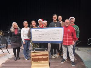 Vicki Campbell of Gerstner & Sons (left) joined students on the stage to present check