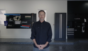 Chris Harrison stands in his newly renovated garage