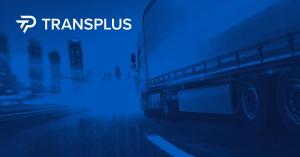 Commercial Truck Driving on a Freeway with City Lights in Background and White TransPlus Logo