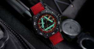 Limited edition Luminox ICE-SAR 1080 Series wristwatch with glowing Luminox Light Technology tubes, red fabric on top of rubber strap, and high-contrast dial, photographed in a low-light setting to highlight night-time readability.