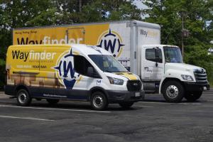 As 2026 begins, many Amherst residents are turning their New Year's resolutions into reality by planning strategic relocations Yellow and navy Wayfinder Moving Services truck ready to serve Amherst families with local and long-distance moves