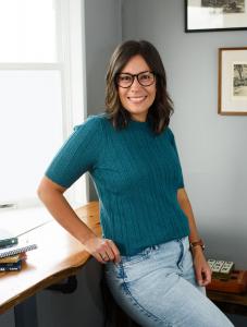 Christine Zell is seen at Chapman's Coffee House with some of her favorite picture books sitting in the window.