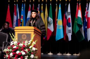 Dr. Mautra Staley Jones delivering remarks at OCCC commencement to group of students.