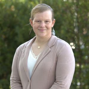 Danielle Joleigh Bennett (a. k. a. Dani Jo) is the leader organizations call when the stakes are high and the margin for error is razor thin. A veteran, parent, coach, and founder, Ms. Bennett built her career in the places at the intersection of complexity, pressure, and accountability, across the U.S. Navy, aerospace, defense contracting, and enterprise transformation. For more than two decades, she has taken on the high-risk initiatives, the ones others hesitate to touch, consistently converting instability to operational clarity and sustainable performance.
As the Founder, President, and CEO of Radiant Legacy Collective, Inc., Ms. Bennett leads a multi-brand strategic architecture company dedicated to building human-forward systems and ventures that scale with integrity. She guides strategy, intellectual property, product performance, and enterprise launches—all anchored in the company’s proprietary frameworks, including Leadership Voltage™, VoltageSystem™ (Formerly GraceGlow™), and the Radiant Resilience Framework. These systems reframe leadership development by measuring human metrics alongside financial results, making growth operational, trackable, and genuinely transformative.
Growing up in a world where traditional roles were shifting and expectations were anything but simple, Dani Jo learned early what it meant to carry responsibility with intention. Her path to leadership began with mastering self-management; skills forged not in classrooms, but in the midst of real challenges rooted in resilience, clarity, and courage. Those formative experiences didn’t just shape who she was; they became the foundation of her leadership philosophies.
Ms. Bennett is also the architect behind Voltage Brands, a commercial portfolio that brings Leadership Voltage™ to life in the marketplace. Through Franchise Voltage and Business Voltage, she translates leadership theory into real-world capability, delivering franchise consulting, operational readiness, entrepreneurial coaching, curated networks, and practical toolkits. Voltage Brands exists to turn leaders into builders and businesses into scalable, sustainable engines. Her work is guided by more than credentials; it carries the imprint of her personal resilience and the hard-won insights that come from lived experience.
Through DS7 Precision Strategies, her executive strategy and consulting practice under Radiant Legacy Collective, Dani Jo works directly with entrepreneurs, franchisors, and executives who want disciplined growth without losing their human center. She provides hands-on coaching, leadership recovery, commercialization support, and the operational playbooks that help organizations scale with clarity and confidence.
Her work extends into the government sector through DS7 LLC, her forward-facing Service-Disabled Veteran-Owned Small Business. There, Dani Jo confronts high-risk challenges head-on, supporting program recovery, supply-chain integration, manufacturability assessments, and mission-critical operational turnarounds. When government programs demand technical rigor, rapid stabilization, and performance under pressure, DS7 LLC is often the partner of choice.
Across her distinguished career, Dani Jo has managed more than $1.2 billion in defense contracts, led joint military support across Iraq, Syria, Kuwait, and Turkey, and built a reputation for rescuing failing programs others had written off. She has contributed to critical national defense efforts, including Columbia-class submarine initiatives and medium voltage medium frequency programs, consistently delivering results on time, on budget, and under extraordinary circumstances.
Her leadership style blends operational discipline with a deep understanding of people. A certified executive coach and practitioner of Soft Power for Hard Systems™, Dani Jo combines emotional intelligence with tactical rigor to build organizations that don’t just withstand disruption, they grow stronger because of it. Through executive coaching, practitioner training, conference programming, and digital toolkits, she equips leaders to convert turbulence into durable advantage. She shines as a beacon of clarity and intentionality, illuminating the way for leaders seeking direction and purpose.
Ms. Bennett brings mainstream credentials and lived leadership experience to her work. A proud veteran, she completed some of the U.S. Navy’s most demanding professional programs and holds a Master of Science in Acquisition and Supply Chain Management. Her background spans military, corporate, and entrepreneurial leadership, supported by formal training through the Harvard Business Analytics Program, advanced joint professional military education, emergency management, and federal contracting. She is a certified Project Management Professional, a certified Everything DiSC partner, and a John Maxwell–certified leadership coach. Ms. Bennett has been recognized by Marquis Who’s Who of America, including Top Professional honors for 2025-2026, for her contributions to leadership and business consulting. She is actively advancing her professional speaking and leadership platform, integrating certified leadership frameworks with original methodologies developed through real-world application.
Community remains central to everything she builds. Dani Jo coaches youth sports, serves as a youth activities director, and mentors in her hometown, believing that leadership starts early, grows through service, and is measured by the strength of the communities it uplifts. She champions inclusive employment, fair wages, and economic ecosystems that help small businesses and families thrive.
At the heart of Ms. Bennett’s work lives a simple promise: to steward legacy while building radiance. She believes in the value of ongoing learning. And she remains steadfast in her commitment to elevating and expanding the field of leadership development. Her upcoming book and Leadership Voltage programs will extend that promise into conferences, certifications, and tools designed to transform how leaders rise, rebuild, and lead with purpose.
Learn more about Dani Jo in her upcoming interviews with Jim, where she shares her journey, fresh ideas, innovations, and unique perspectives. You’ll walk away with greater clarity, and plenty of inspiration.
Close Up Radio recently featured Danielle Joliegh Bennet in a two-part interview with Jim Masters on Tuesday December 23rd at 11am Eastern, and on Tuesday January 13th at 10am Eastern
Listen to the Podcast
https://podcasts.apple.com/us/podcast/part-1-close-up-radio-spotlights-danielle-joleigh-bennett/id1785721253?i=1000742596756
https://www.iheart.com/podcast/269-close-up-radio-242020413/episode/part-1-close-up-radio-spotlights-314615037/
https://open.spotify.com/episode/5851XE3U67rAhHFnzn3uF8
For more information, visit www.radiantlegacycollective.com
Written By: Beatrice Maria Centeno DanielleBennett1