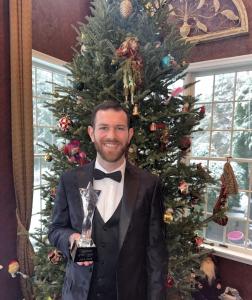 The New York Today has named Josh Pele its 2025 Magician of the Year, recognizing a New York–based magician and mentalist whose work reflects a fresh and thoughtful approach to contemporary magic Josh in front of a tree