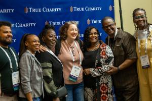 Photo of smiling attendees at True Charity Summit conference