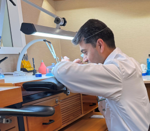 Rolex Level 50 watch being serviced by a certified watchmaker at a precision workbench