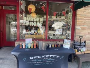 Beckett's sampling table in front of Pasadena's Non-alcoholic bottle shop, Burden of Proof