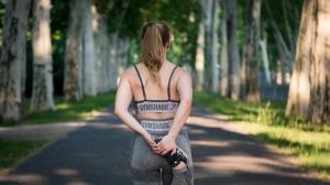 Healthy woman jogging outdoors, representing sustainable exercise and longevity guidance from beyondMD.