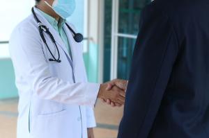 Professional executive meeting with a physician, representing personalized and concierge healthcare services by Mosaic Medicine.