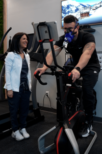 Patient completing VO₂ Max testing on a cycle ergometer using the PNOĒ system at MetaLab inside Confidia Health Institute in Bristol, Connecticut.