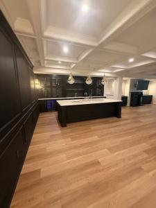 Absolute Renovations Group Now Offers Flexible Financing Options for Home Renovation Projects 7 completed residential basement featuring custom cabinetry, a large island, coffered ceilings and recessed lighting