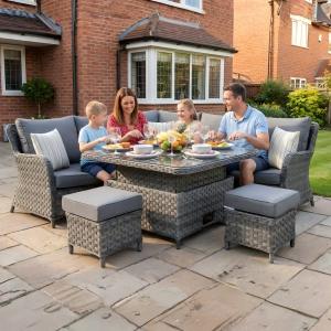 Garden furniture dining table and chairs by Rattan Garden Furniture LTD Essex in a family garden setting