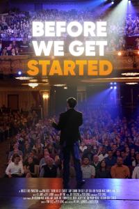 A man standing in front of an audience with a microphone doing comedy