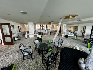 SERVPRO green air movers and dehumidifiers drying upscale condominium lobby with ornate ceiling medallions, custom furnishings, and decorative columns in Naples Florida