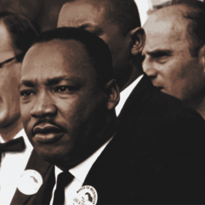 Dr. Martin Luther King Jr. speaking to a large crowd during a historic public gathering.
