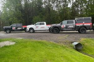RJR Demolition & Junk Removal trucks parked at a demolition site.