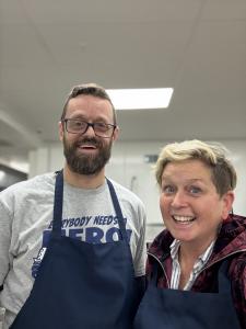 A man and Women smiling food entrepreneurs in an aprons showing enthusiasm to be creating something special for Pittsburgh Community a