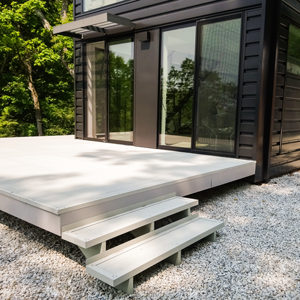 Aluminum AridDek waterproof deck system installed on an outdoor residential deck, showcasing interlocking boards designed for durability, drainage, and reduced walking noise with Quiet Step Technology.