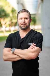 Doctor wearing black Titan performance medical scrubs outdoors