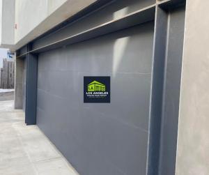 Modern custom wood garage door installed on a luxury home in Los Angeles, California